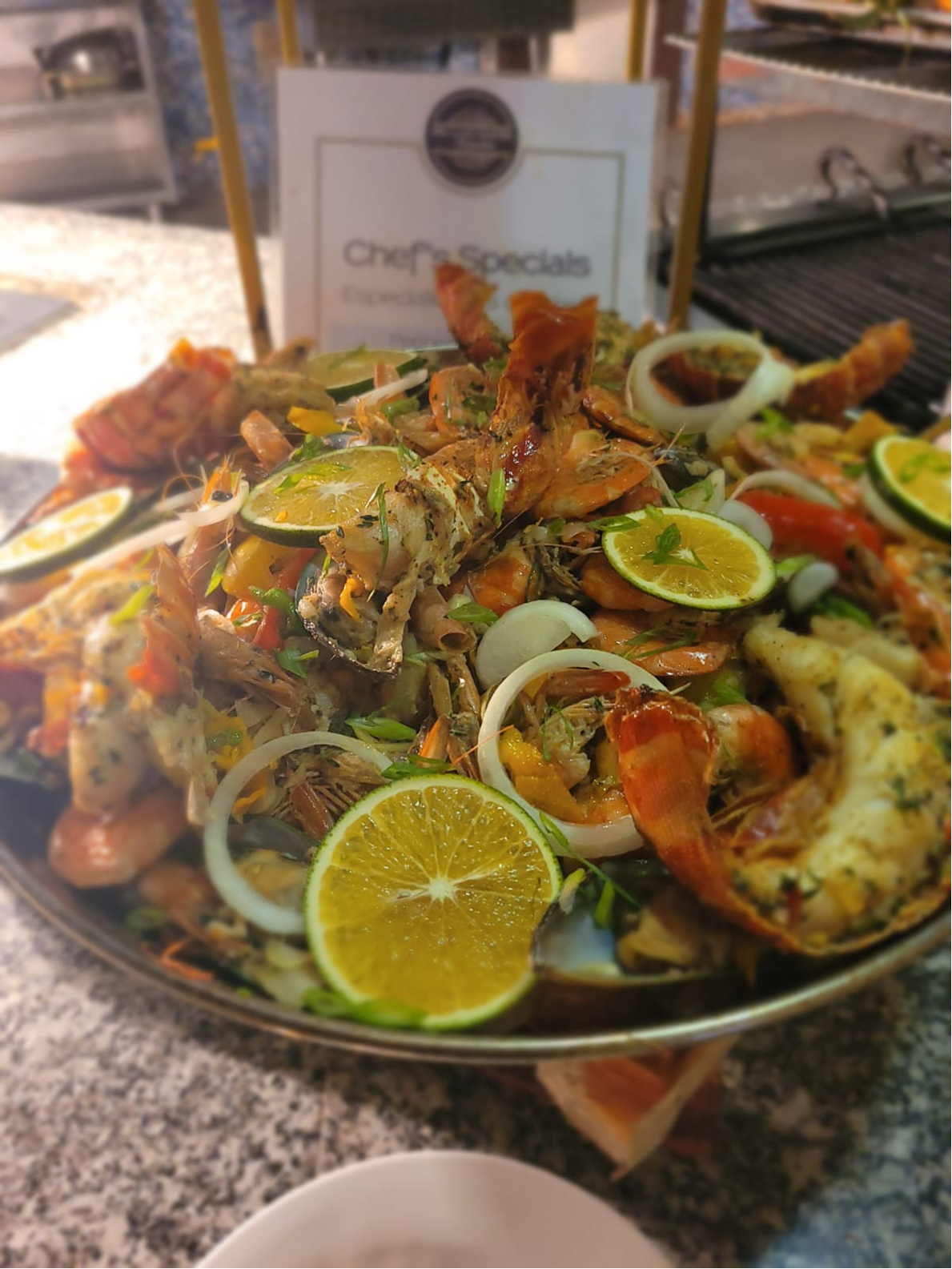 Chef's Special seafood platter with lobster, shrimp, lime, and herbs.