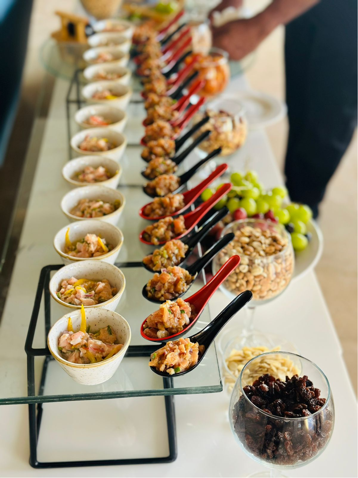 Small appetizers and spoons displayed for catered service.