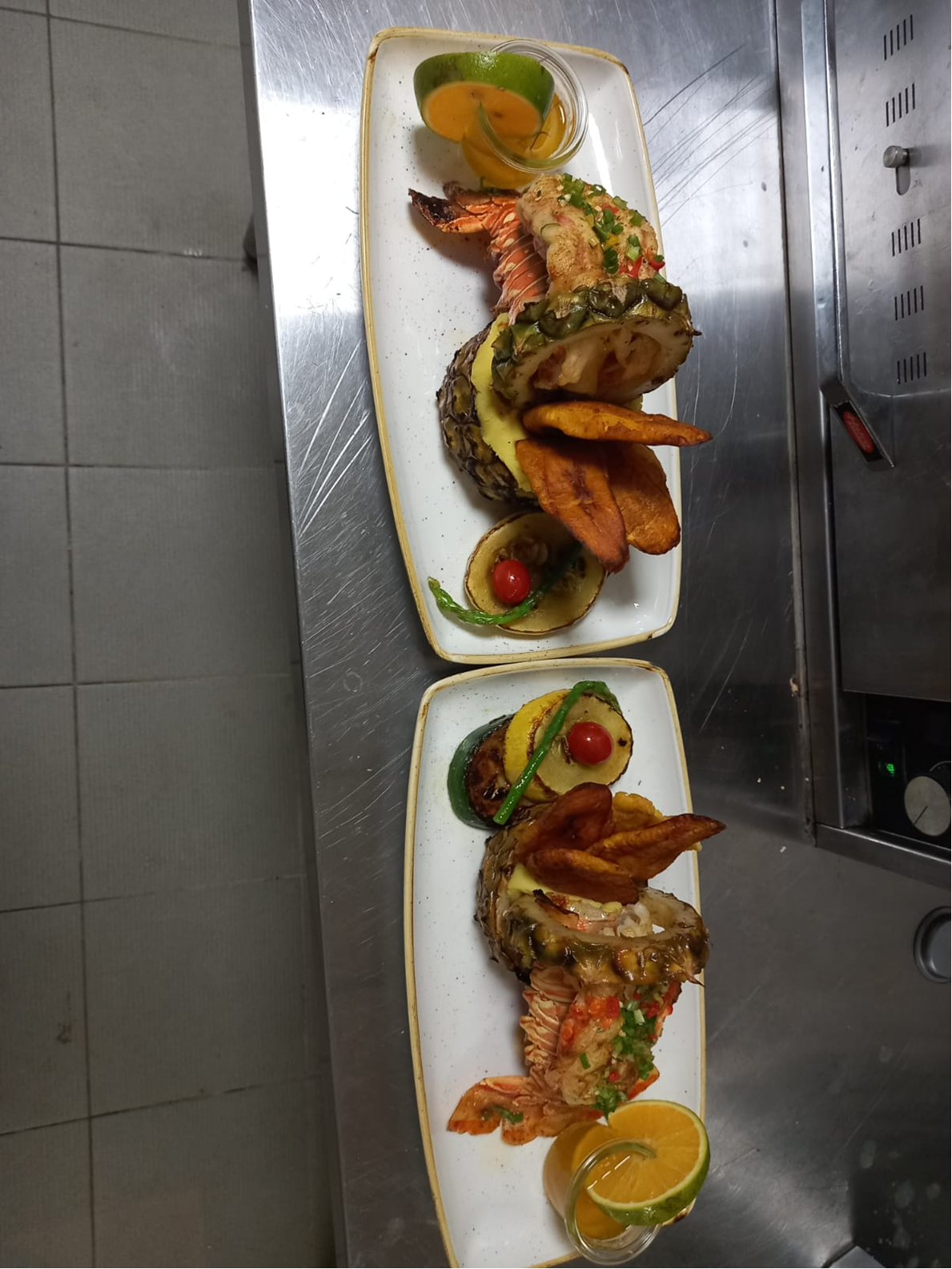 Lobster plated in pineapple shells with plantain chips and citrus sauce.